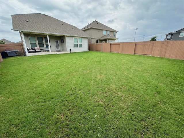 rear view of house with a yard and a patio area