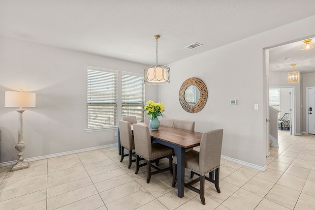 dining space featuring light tile patterned floors