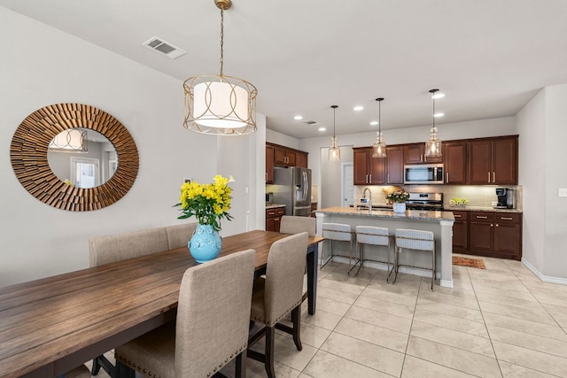 tiled dining room with sink