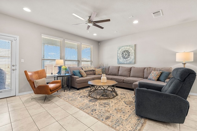 tiled living room featuring ceiling fan and plenty of natural light