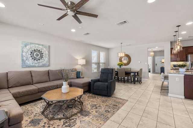 living room featuring light tile patterned flooring and ceiling fan