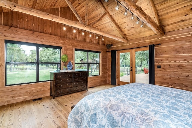 bedroom with wood walls, wooden ceiling, french doors, lofted ceiling with beams, and light wood-type flooring