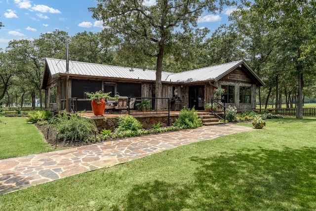 rear view of house with a yard