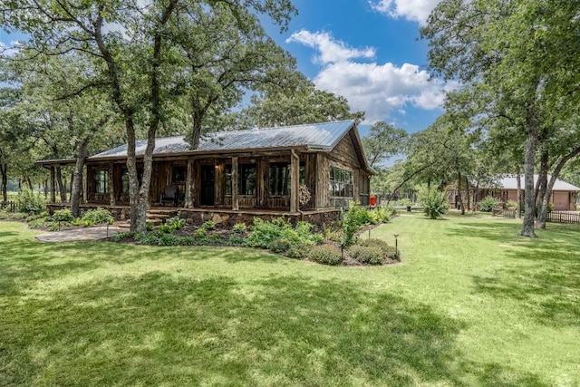 rear view of property with a yard