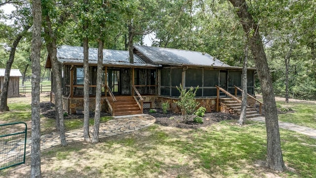 view of front facade with a sunroom