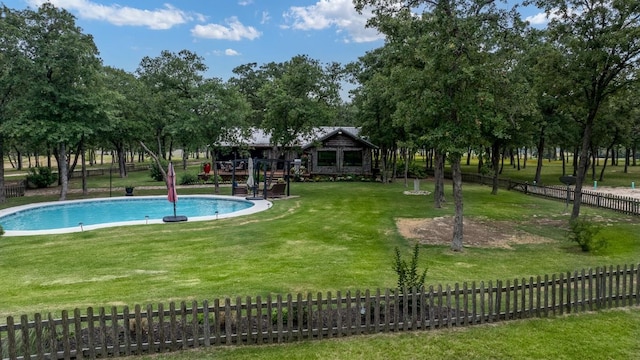 view of pool featuring a yard