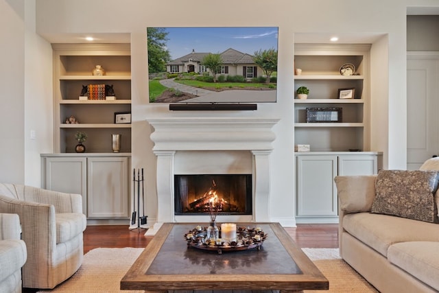 living room featuring hardwood / wood-style floors and built in features