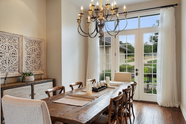 dining space featuring hardwood / wood-style floors, french doors, and a chandelier