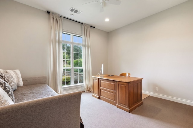 carpeted office space with ceiling fan