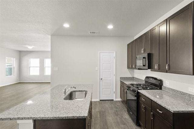 kitchen featuring light hardwood / wood-style floors, stainless steel appliances, sink, and light stone counters