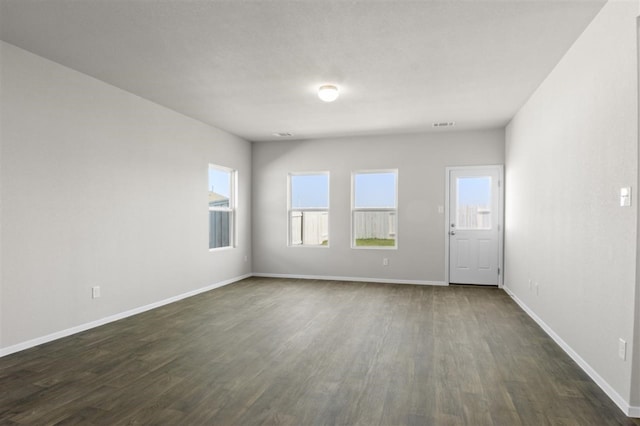 unfurnished room featuring dark hardwood / wood-style flooring