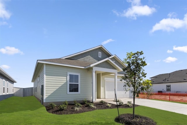 view of front facade featuring a garage and a front lawn