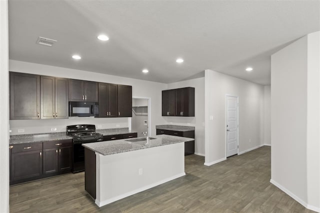 kitchen with visible vents, recessed lighting, wood finished floors, black appliances, and a sink