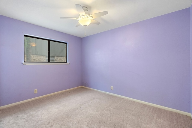 empty room with carpet floors and ceiling fan