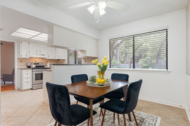 dining area featuring ceiling fan and light tile patterned floors