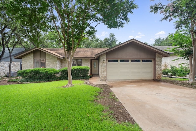 ranch-style house featuring central air condition unit, a front yard, and a garage