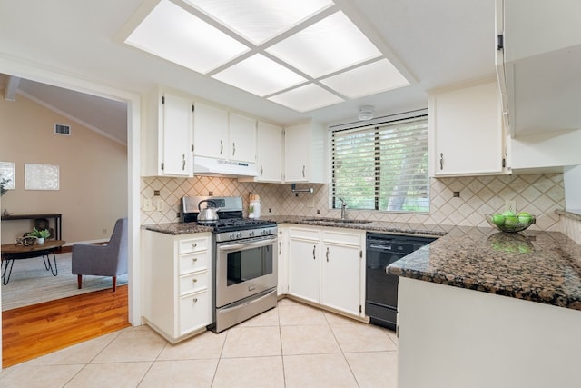 kitchen with light tile patterned flooring, white cabinets, dishwasher, vaulted ceiling, and stainless steel range with gas stovetop