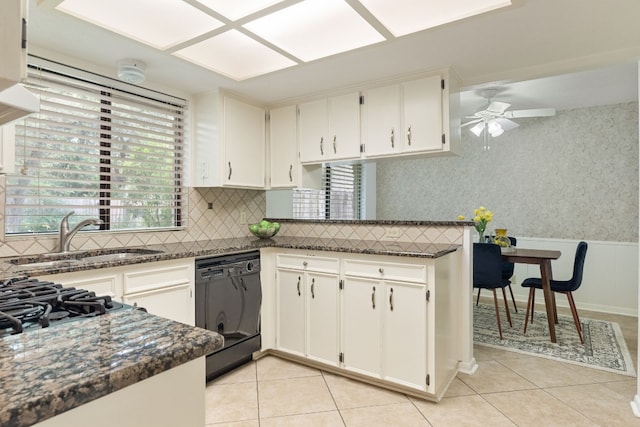 kitchen with sink, white cabinets, dishwasher, and a healthy amount of sunlight