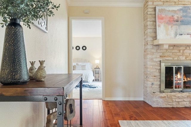 interior space featuring crown molding, a fireplace, and wood-type flooring