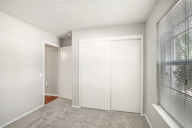 unfurnished bedroom featuring carpet floors and a closet