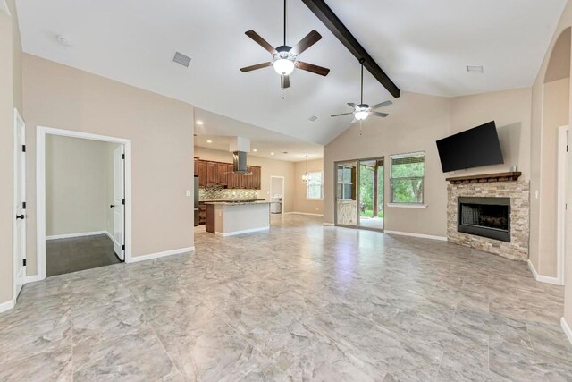 unfurnished living room featuring a fireplace, ceiling fan with notable chandelier, high vaulted ceiling, and beamed ceiling