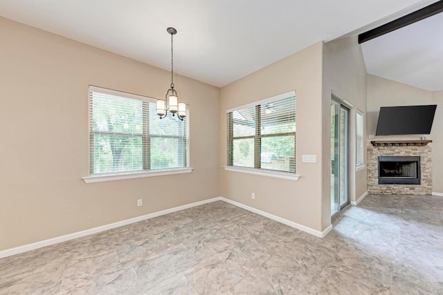 empty room with a notable chandelier, plenty of natural light, a stone fireplace, and lofted ceiling