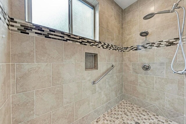 bathroom with a tile shower