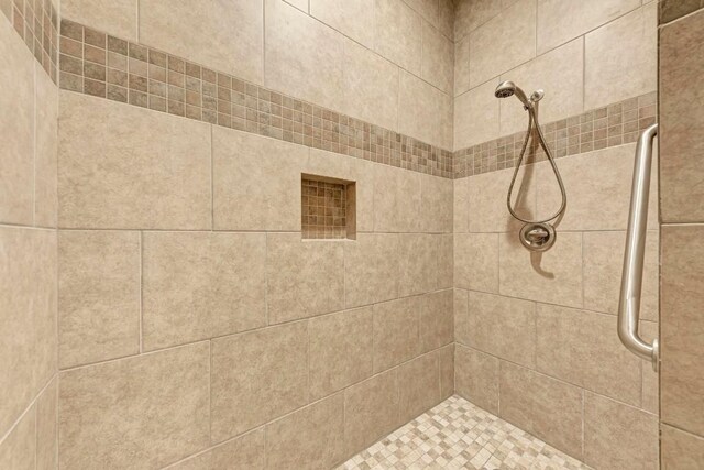 bathroom with tiled shower