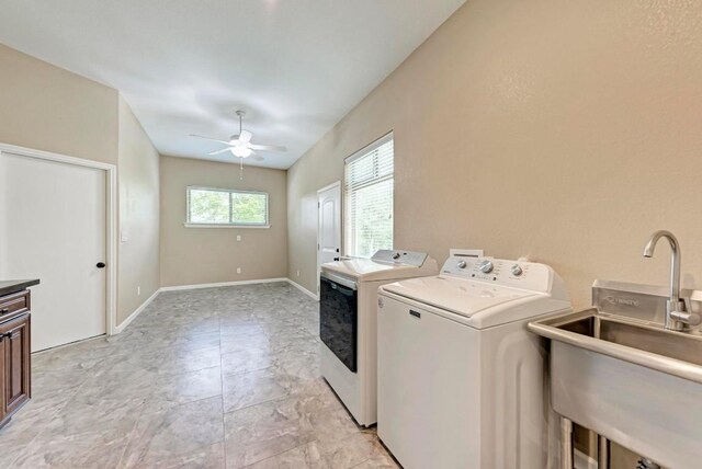 washroom with separate washer and dryer, ceiling fan, and sink