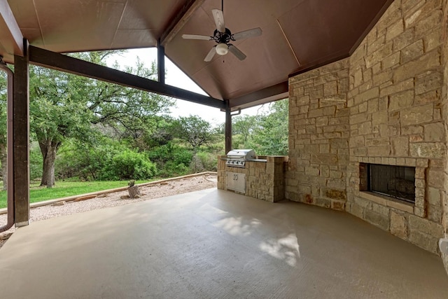 view of patio with area for grilling, ceiling fan, grilling area, and an outdoor stone fireplace