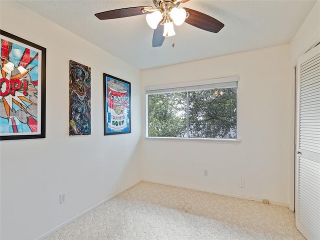 unfurnished bedroom with ceiling fan, light colored carpet, and a closet