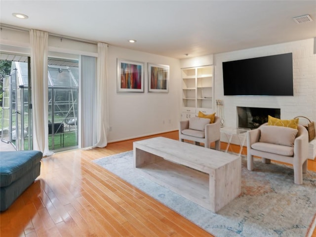 living room with hardwood / wood-style flooring and a fireplace