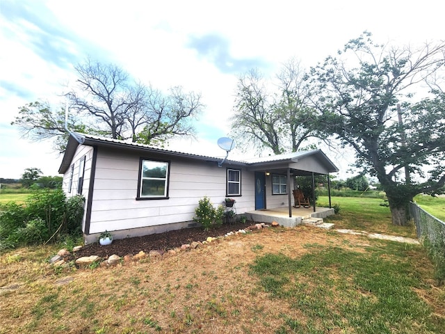 view of front of home with a porch and a front lawn