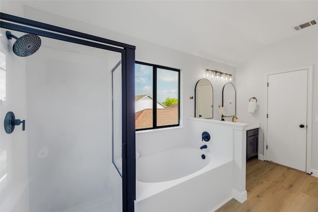 bathroom featuring hardwood / wood-style floors, vanity, separate shower and tub, and lofted ceiling