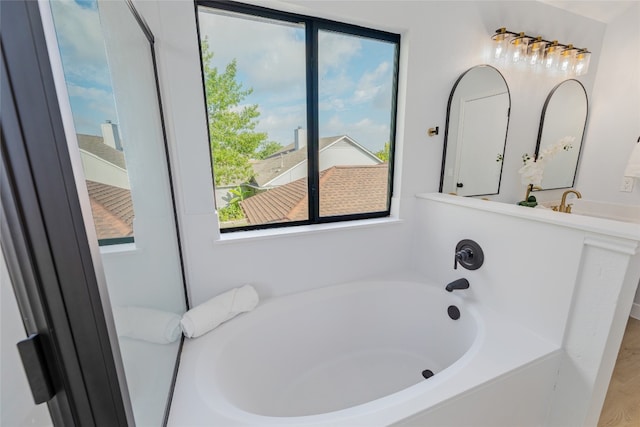 bathroom with a bath and vanity