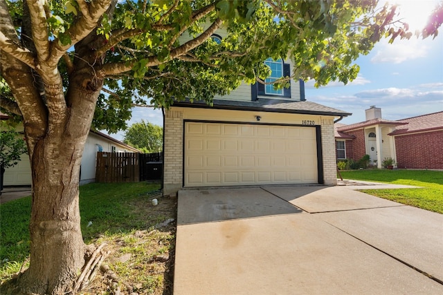 view of front of home with a garage and a front lawn