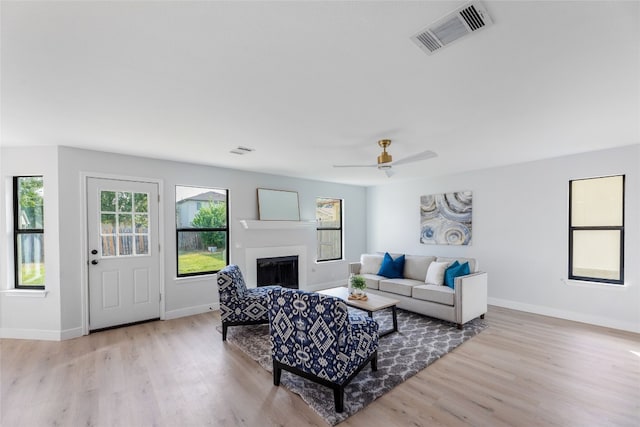 living room featuring light wood-type flooring and ceiling fan