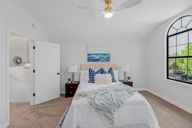 carpeted bedroom with ceiling fan and lofted ceiling