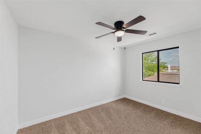 empty room featuring carpet floors and ceiling fan