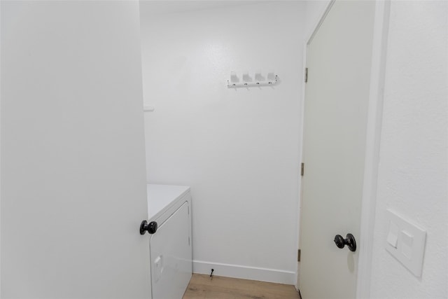 laundry area featuring independent washer and dryer and light hardwood / wood-style floors