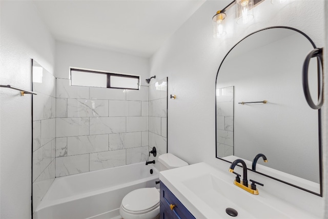 full bathroom featuring vanity, tiled shower / bath combo, and toilet