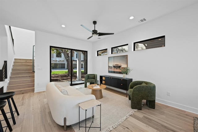 living room featuring hardwood / wood-style flooring and ceiling fan