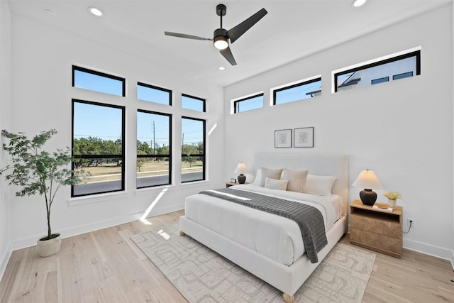 bedroom with ceiling fan and light hardwood / wood-style floors