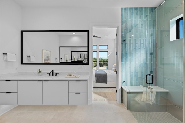 bathroom with tile patterned flooring, vanity, and an enclosed shower