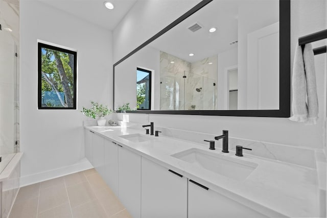 bathroom with tile patterned flooring, vanity, and a shower with door