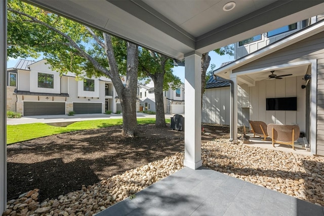 view of patio with a garage and ceiling fan