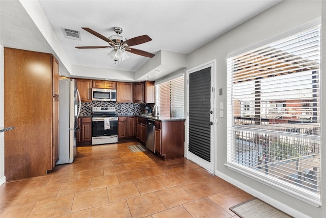 kitchen with decorative backsplash, stainless steel appliances, ceiling fan, sink, and light tile patterned floors