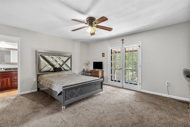 carpeted bedroom with french doors, ensuite bathroom, sink, ceiling fan, and access to exterior