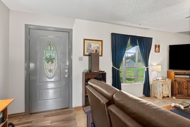 foyer with light hardwood / wood-style flooring and a textured ceiling