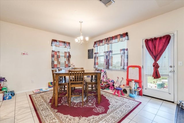 tiled dining area with a notable chandelier